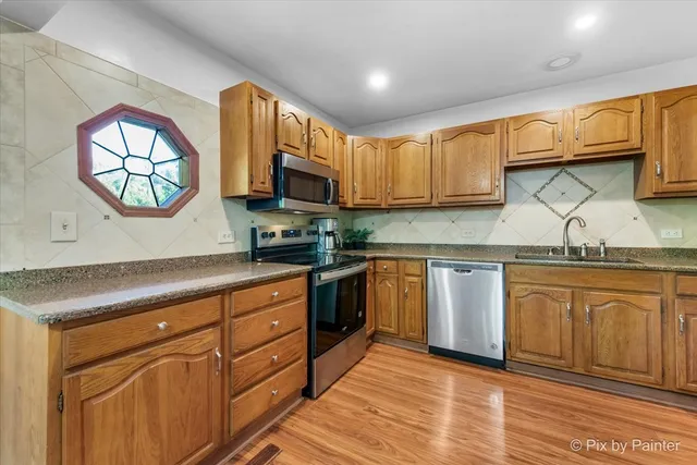 a kitchen with sink cabinets and window