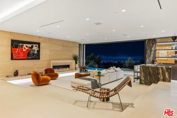 a view of living room with furniture and lots of frames on stairs