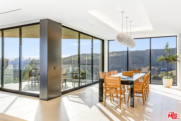 a view of a dining room with furniture window and outside view