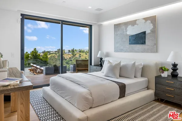 a bedroom with a bed and a couch