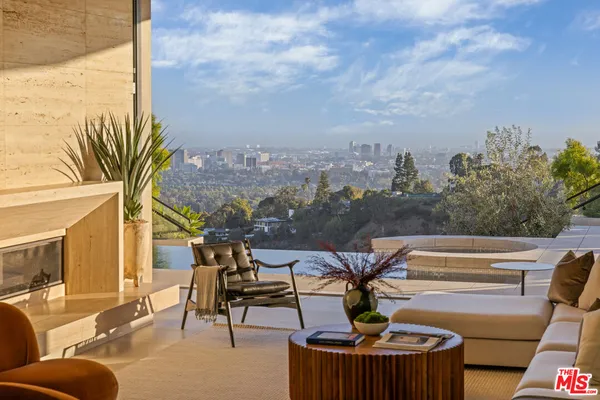 a terrace with outdoor seating and city view
