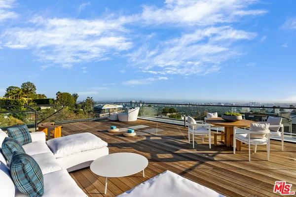 a view of city from balcony with seating space