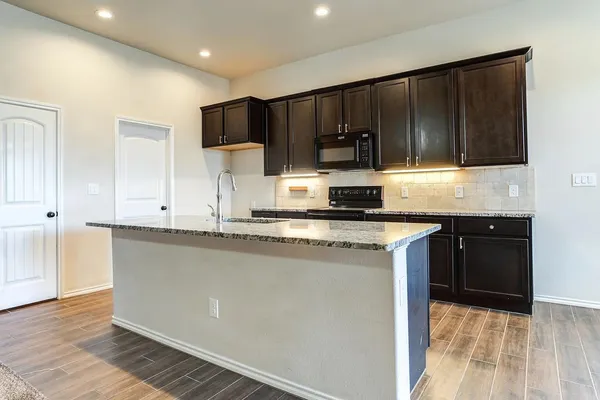 an empty room with a ceiling fan and a window