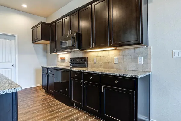 a bathroom with a granite countertop sink a large mirror and a shower