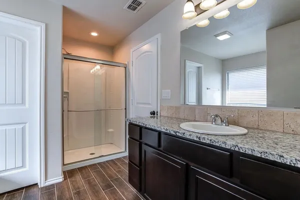 a view of kitchen with kitchen island a sink stainless steel appliances and cabinets