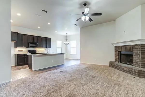 a view of an empty room and fire place