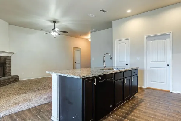 a view of a kitchen with a sink and wooden floor