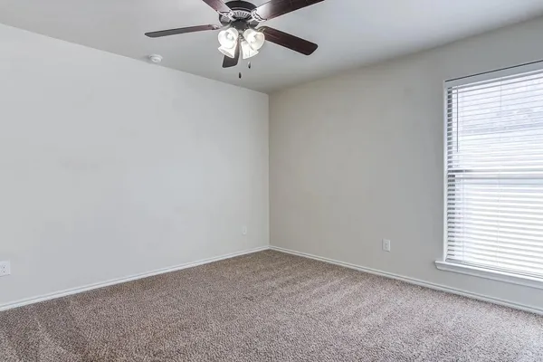 a kitchen with granite countertop a stove and a wooden cabinets