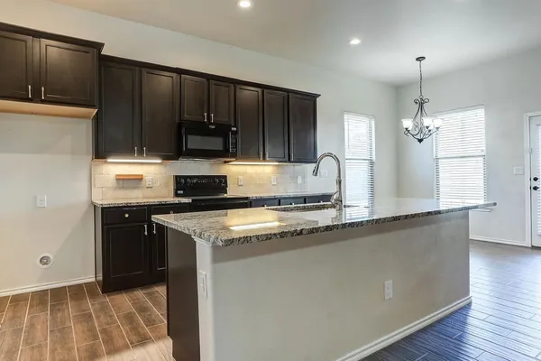 a view of a hallway with wooden floor and closet area