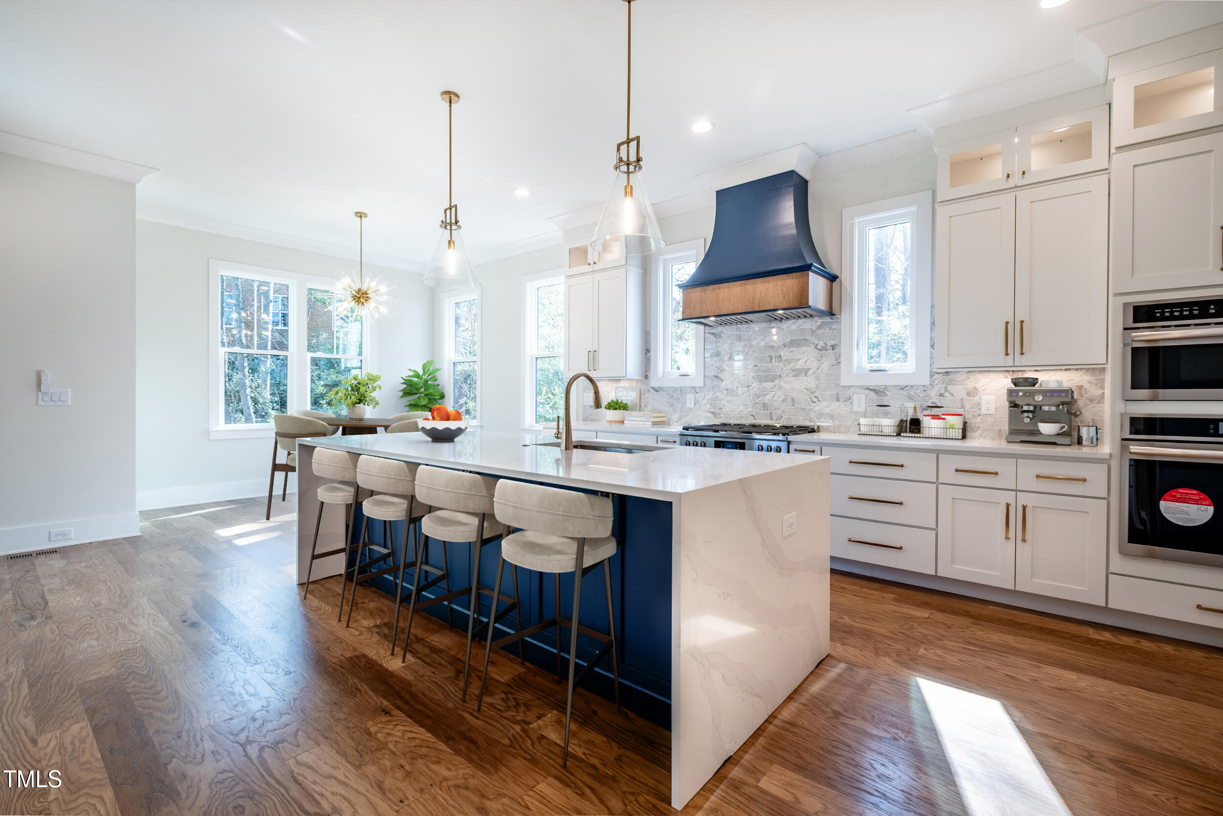 3000 Eden Harbor Court Raleigh, NC 27613 - Photo 3 of 27 a kitchen with stainless steel appliances granite countertop a stove top oven a sink dishwasher and a dining table with wooden floor