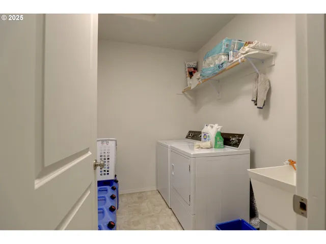 a utility room with a sink dryer and washer