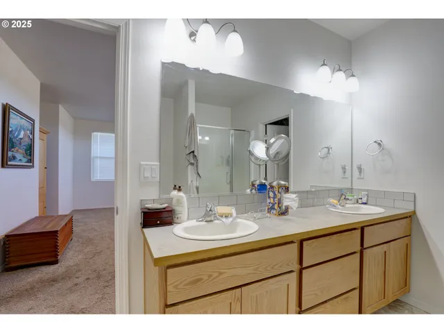 a bathroom with a sink double vanity and a mirror