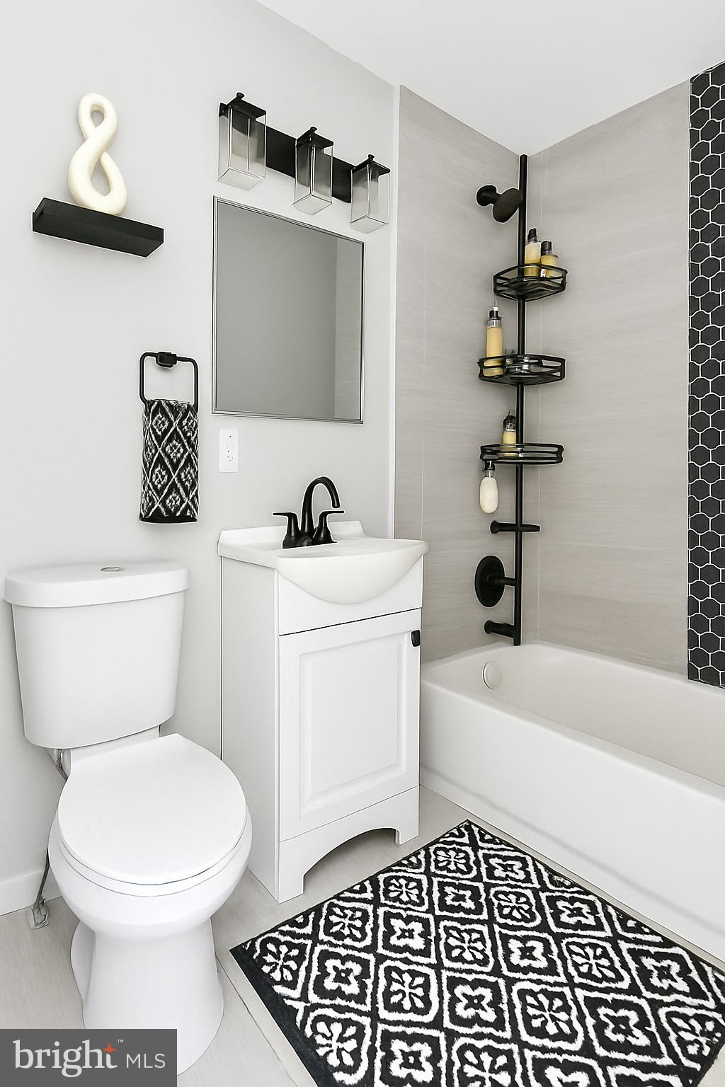 624 North Payson Street Baltimore, MD 21217 - Photo 6 of 8 a bathroom with a toilet a sink and bathtub