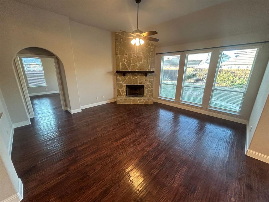 2003 Cheshire Way Forney, TX 75126 - Photo 12 of 35 a view of empty room with wooden floor and fireplace