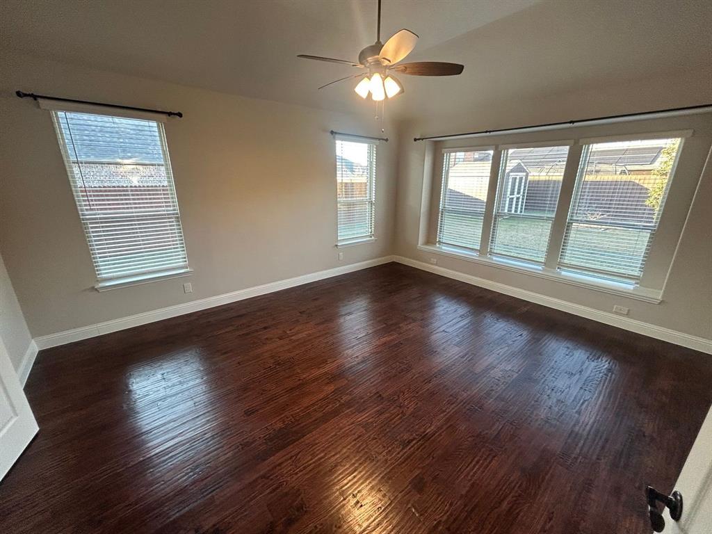 2003 Cheshire Way Forney, TX 75126 - Photo 13 of 35 a view of an empty room with wooden floor and a window