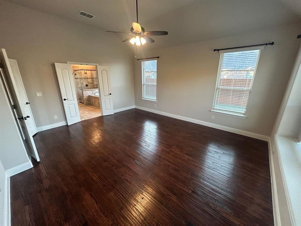 2003 Cheshire Way Forney, TX 75126 - Photo 14 of 35 wooden floor in an empty room with a window