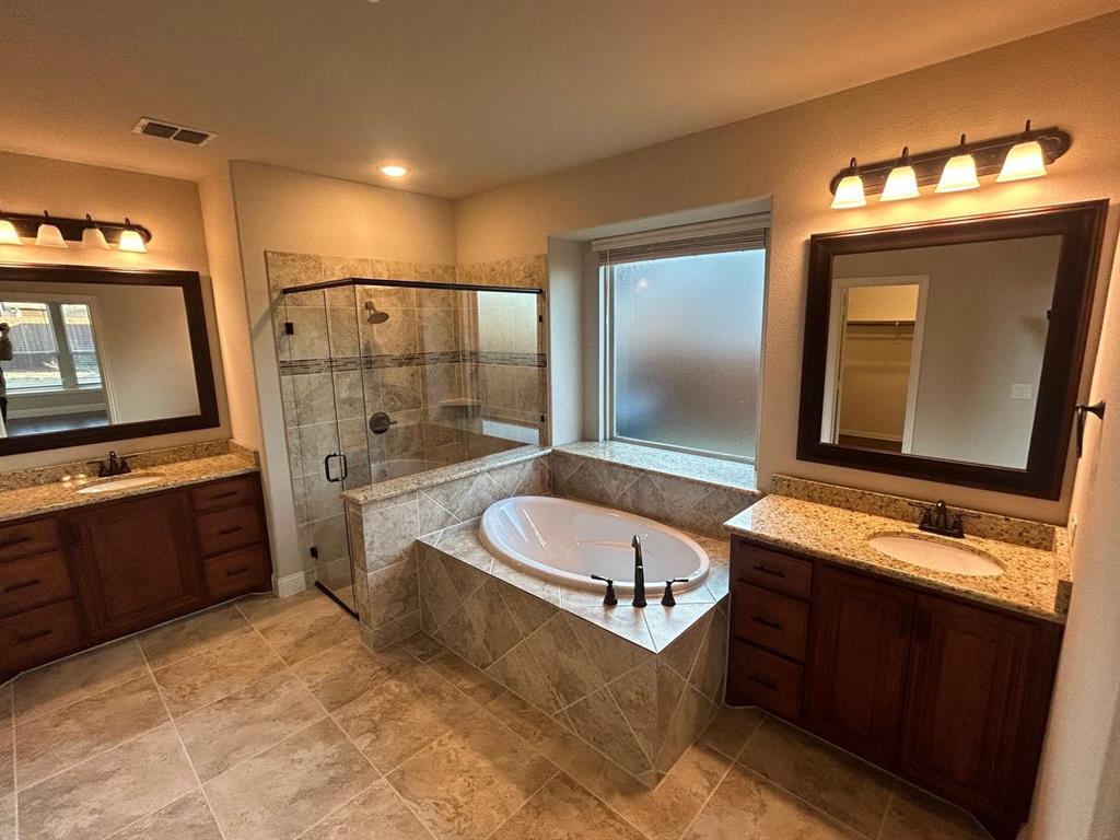 2003 Cheshire Way Forney, TX 75126 - Photo 15 of 35 a bathroom with a bathtub sink and mirror