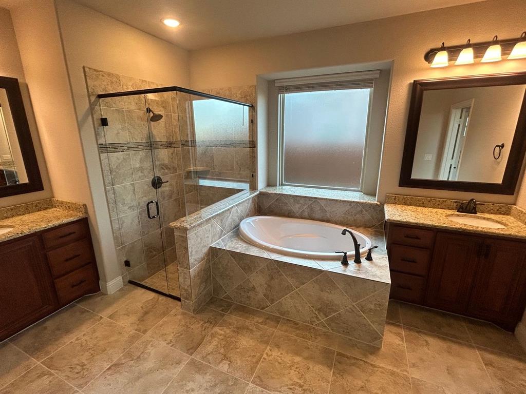 2003 Cheshire Way Forney, TX 75126 - Photo 16 of 35 a bathroom with a tub a sink and a mirror