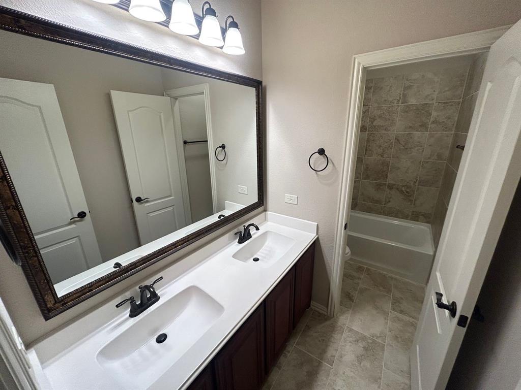 2003 Cheshire Way Forney, TX 75126 - Photo 22 of 35 a bathroom with a tub sink and mirror