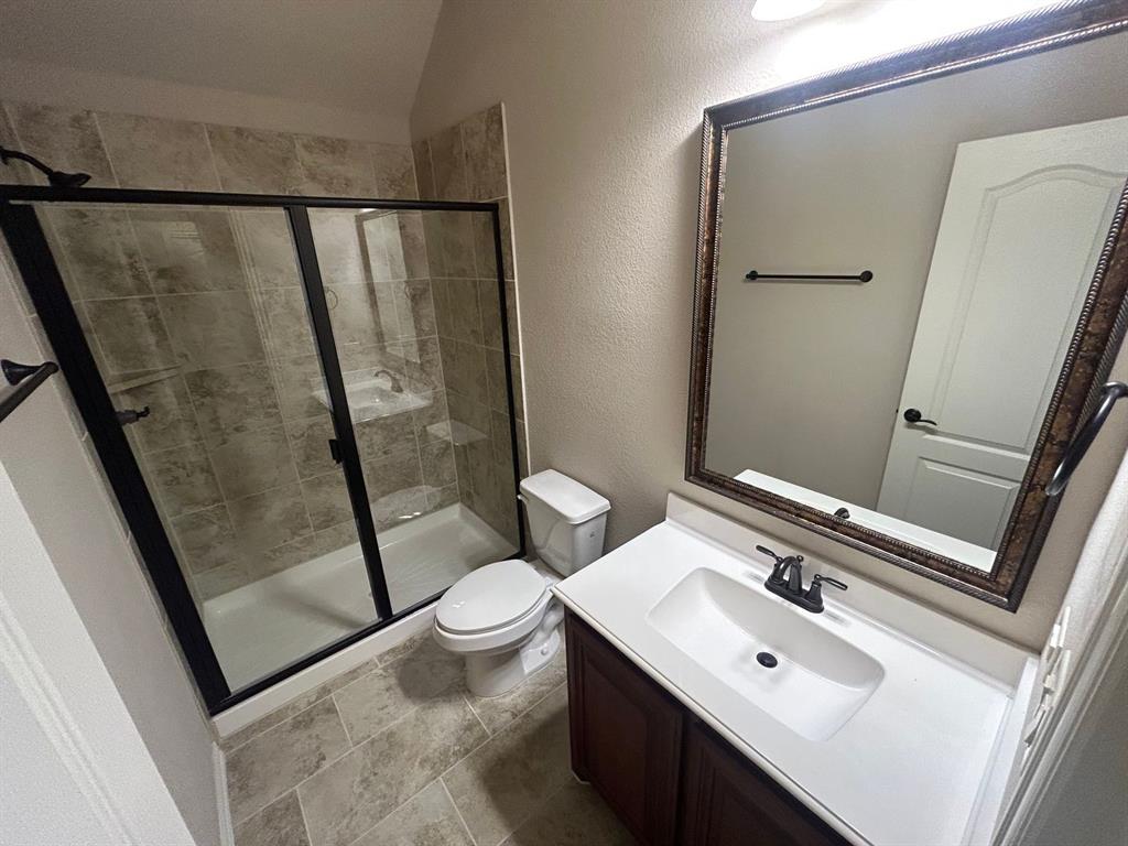 2003 Cheshire Way Forney, TX 75126 - Photo 26 of 35 a bathroom with a sink and mirror with toilet