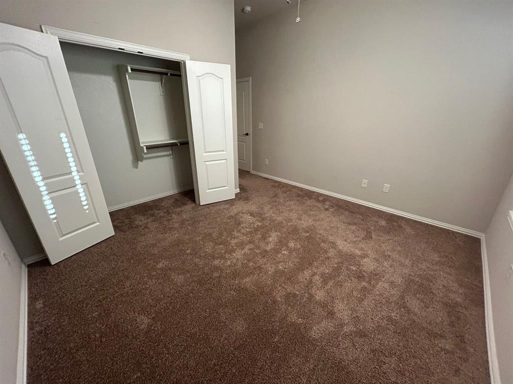 2003 Cheshire Way Forney, TX 75126 - Photo 27 of 35 an empty room with closet and mirror