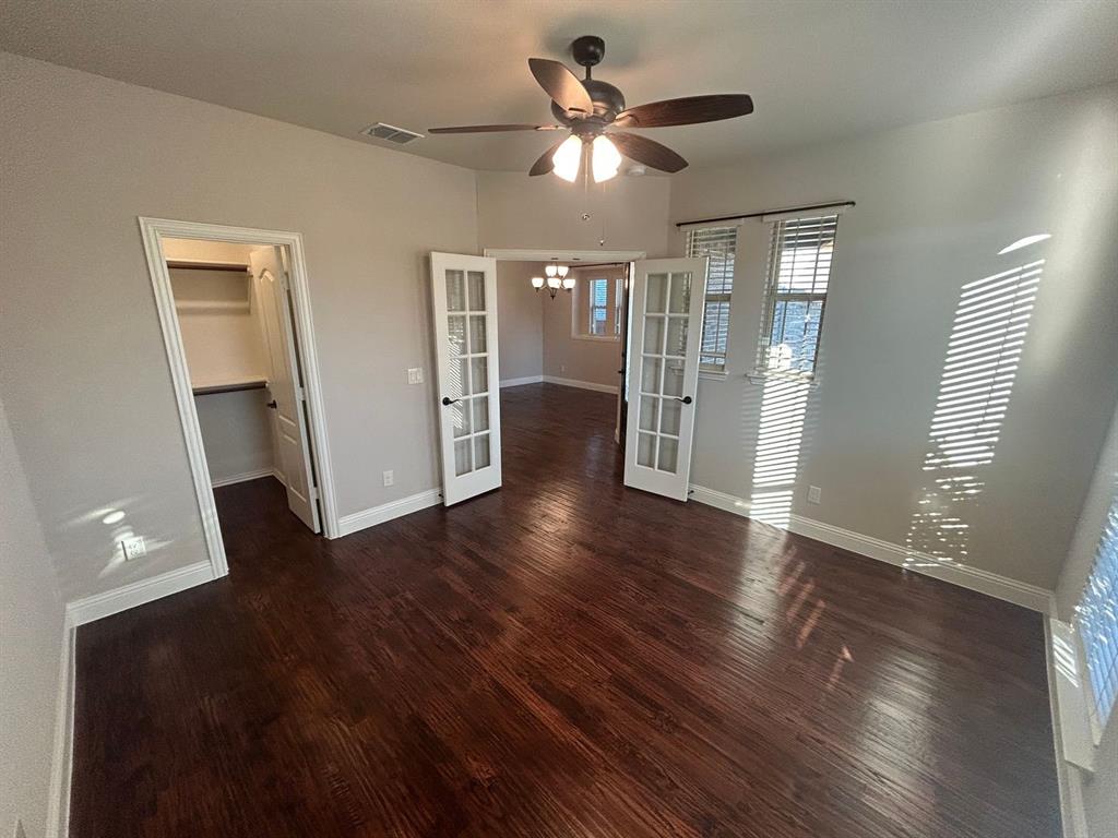 2003 Cheshire Way Forney, TX 75126 - Photo 4 of 35 a view of an empty room with wooden floor and a window