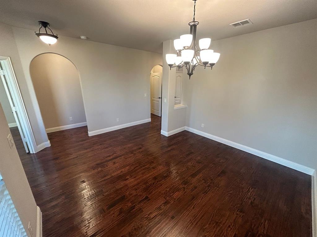 2003 Cheshire Way Forney, TX 75126 - Photo 5 of 35 a view of a chandelier in a room with wooden floor