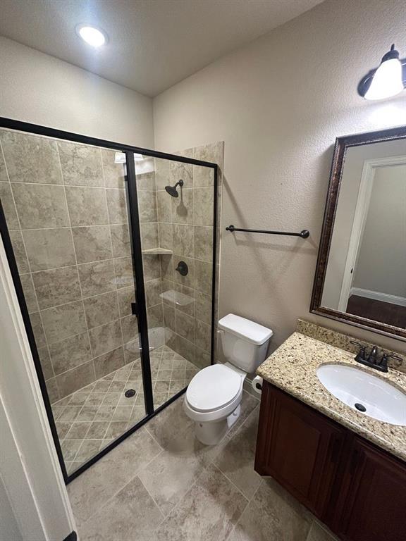 2003 Cheshire Way Forney, TX 75126 - Photo 6 of 35 a bathroom with a granite countertop sink toilet and shower