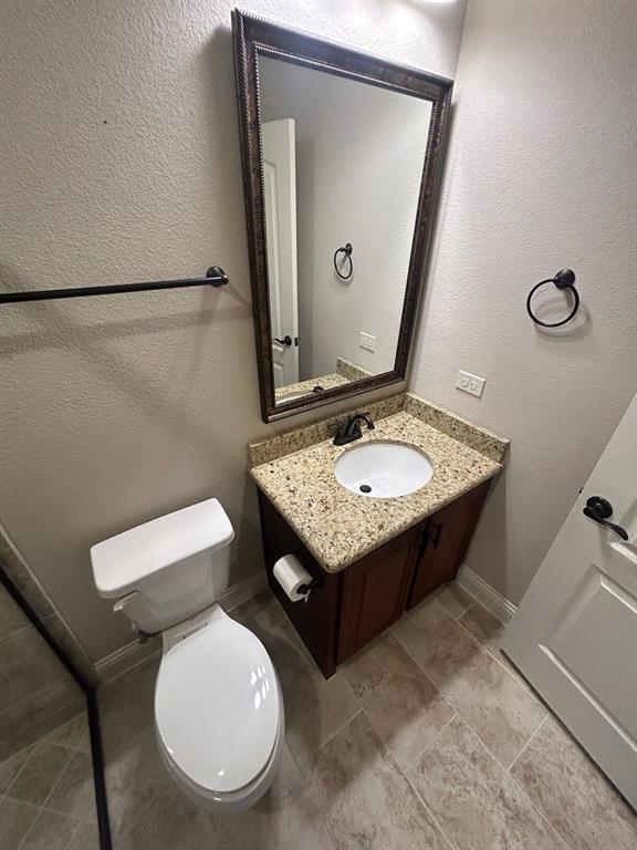 2003 Cheshire Way Forney, TX 75126 - Photo 8 of 35 a bathroom with a toilet a sink and mirror