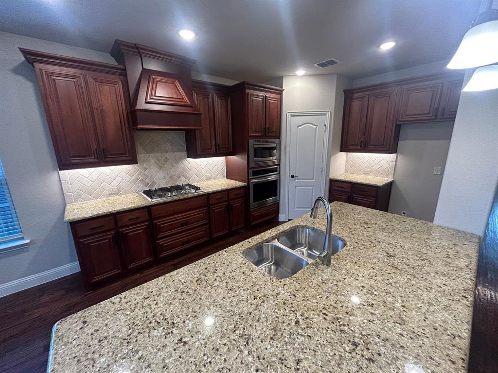2003 Cheshire Way Forney, TX 75126 - Photo 10 of 35 a kitchen with a refrigerator and a sink