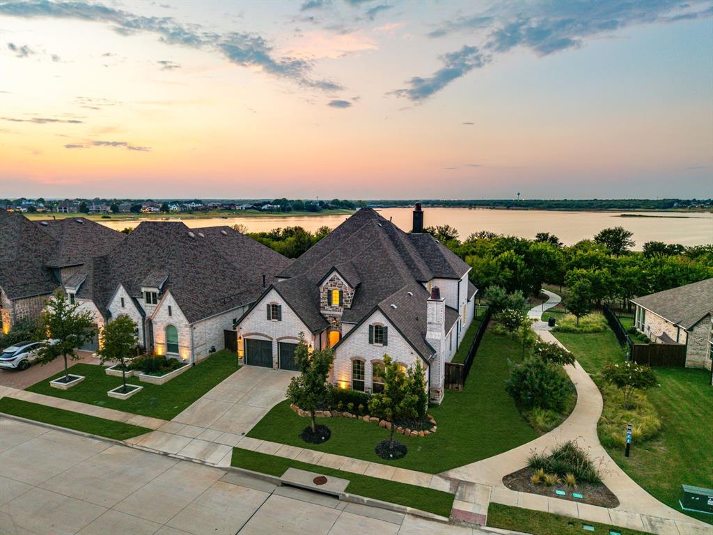 an aerial view of a house with a garden and lake view