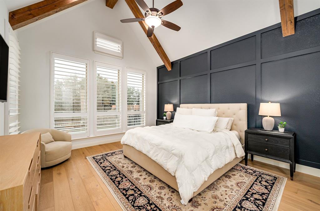 8288 Western The Colony, TX 75056 - Photo 13 of 40 a bedroom with a bed lamps and a large window