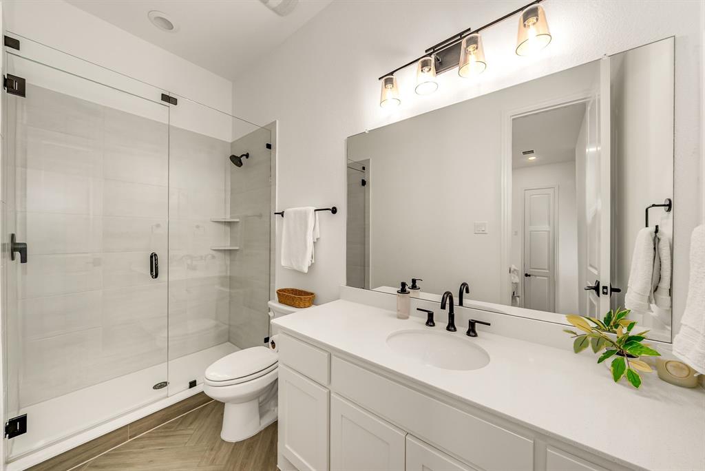 8288 Western The Colony, TX 75056 - Photo 17 of 40 a bathroom with a sink a toilet and shower