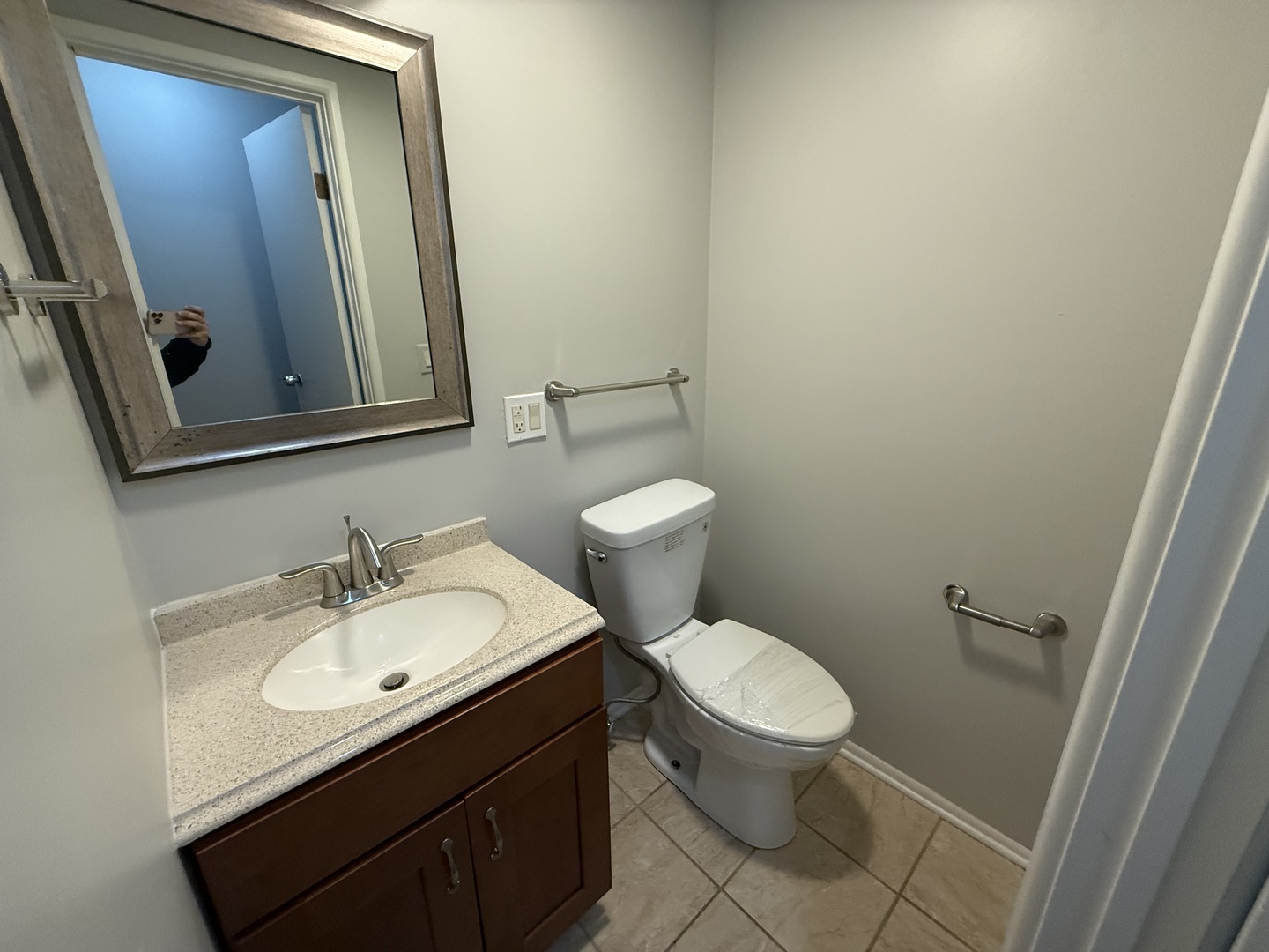 744 West Gordon Terrace, Unit 307 Chicago, IL 60613 - Photo 7 of 12 a bathroom with a toilet sink and mirror