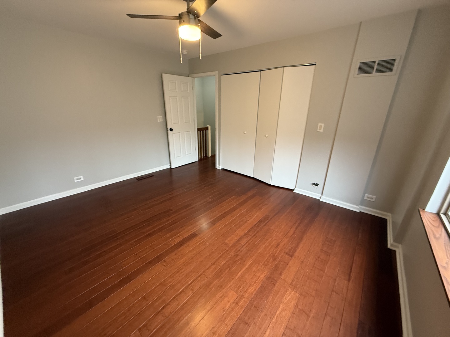 744 West Gordon Terrace, Unit 307 Chicago, IL 60613 - Photo 9 of 12 wooden floor in an empty room with a window