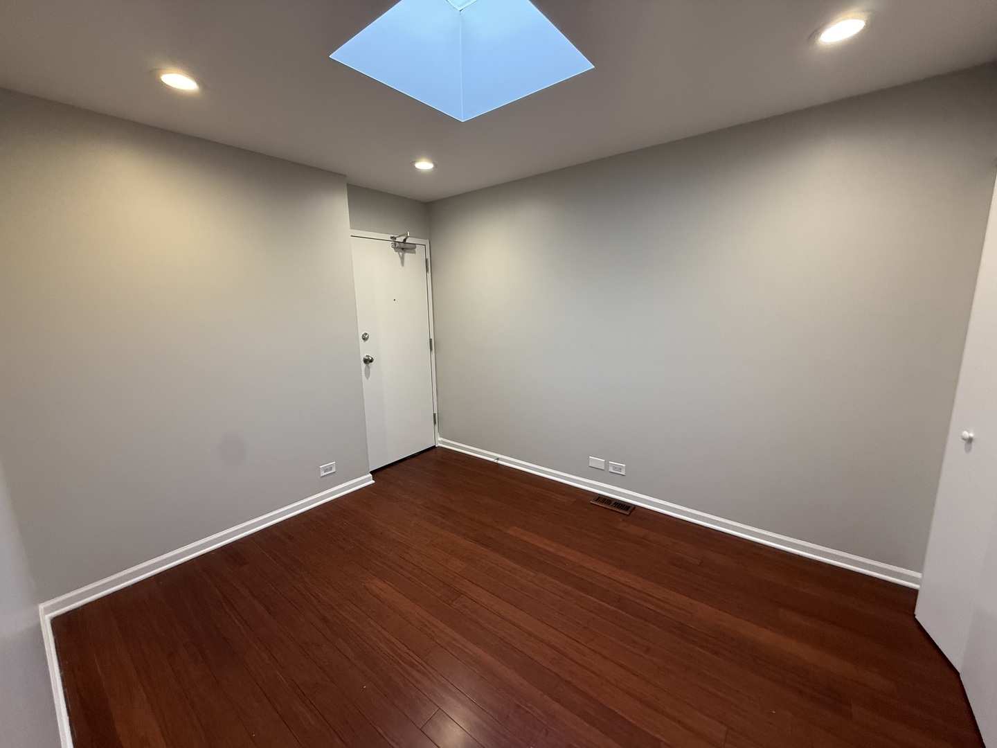744 West Gordon Terrace, Unit 307 Chicago, IL 60613 - Photo 10 of 12 an empty room with wooden floor and windows