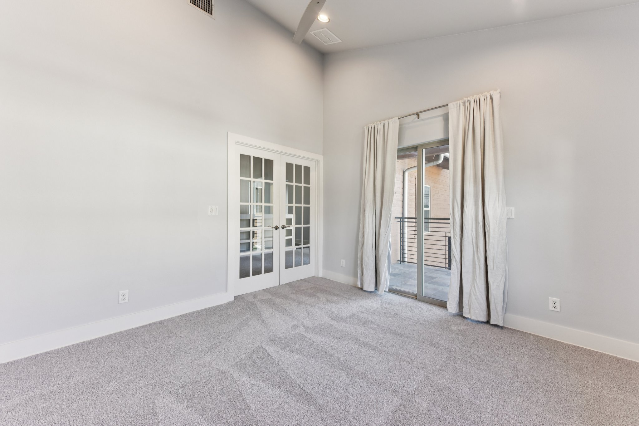 8110 Ranch Road 2222, Unit 98 Austin, TX 78730 - Photo 17 of 37 Unfurnished room with french doors, carpet floors, a towering ceiling, and recessed lighting