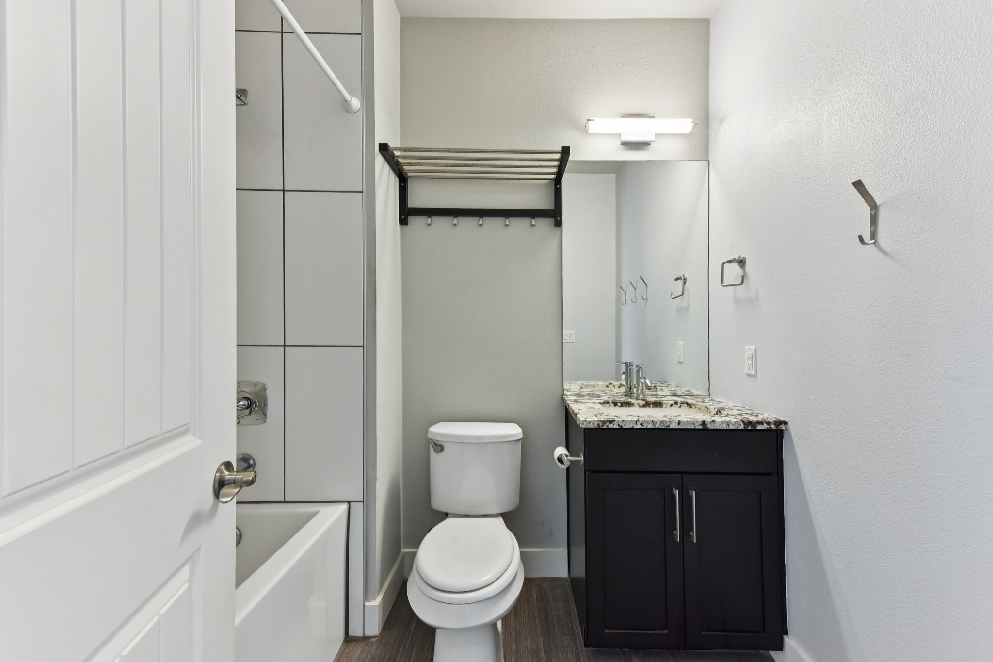 8110 Ranch Road 2222, Unit 98 Austin, TX 78730 - Photo 19 of 37 Bathroom with vanity, bathing tub / shower combination, and dark wood finished floors
