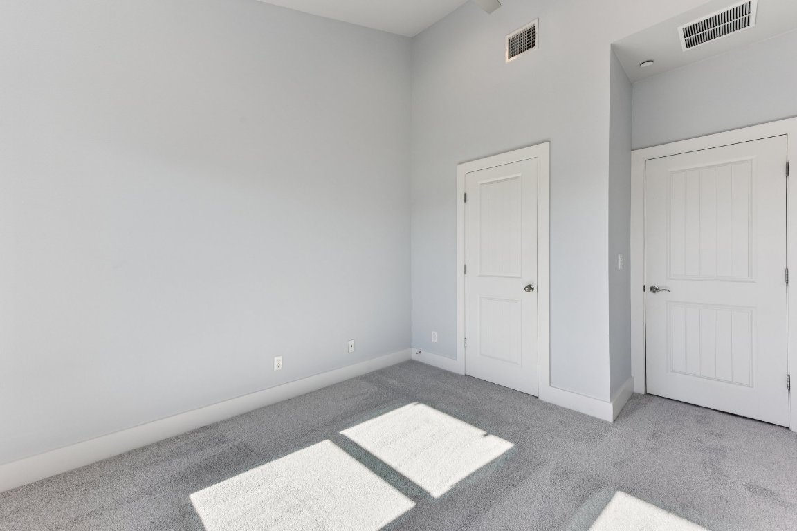 8110 Ranch Road 2222, Unit 98 Austin, TX 78730 - Photo 21 of 37 Unfurnished bedroom featuring baseboards and carpet flooring