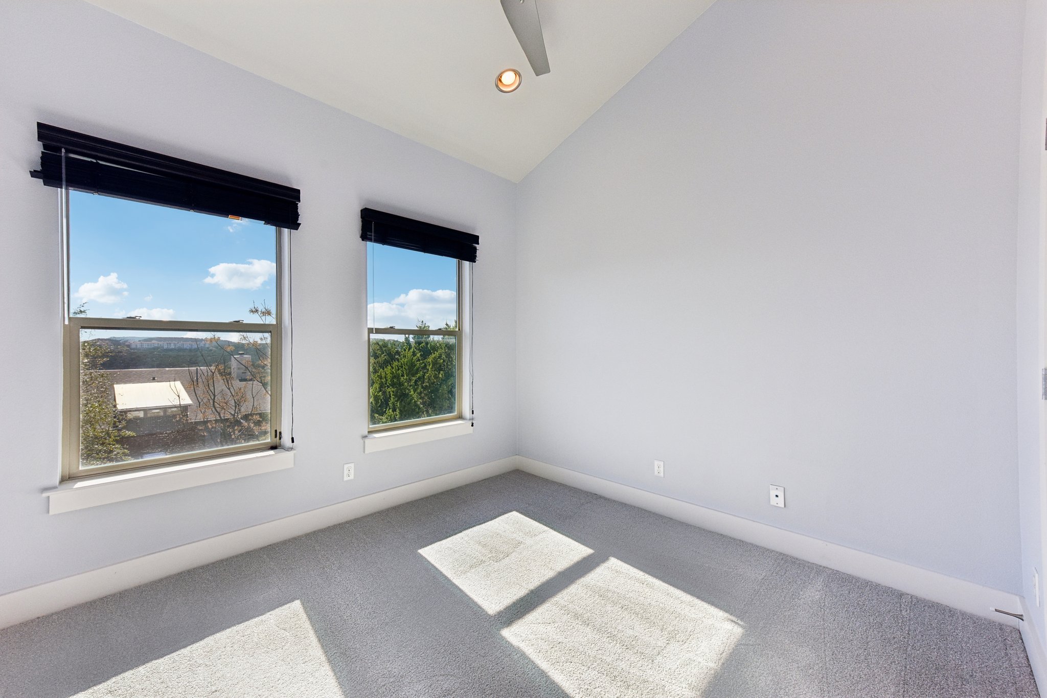 8110 Ranch Road 2222, Unit 98 Austin, TX 78730 - Photo 21 of 37 Spare room featuring vaulted ceiling, carpet flooring, and recessed lighting