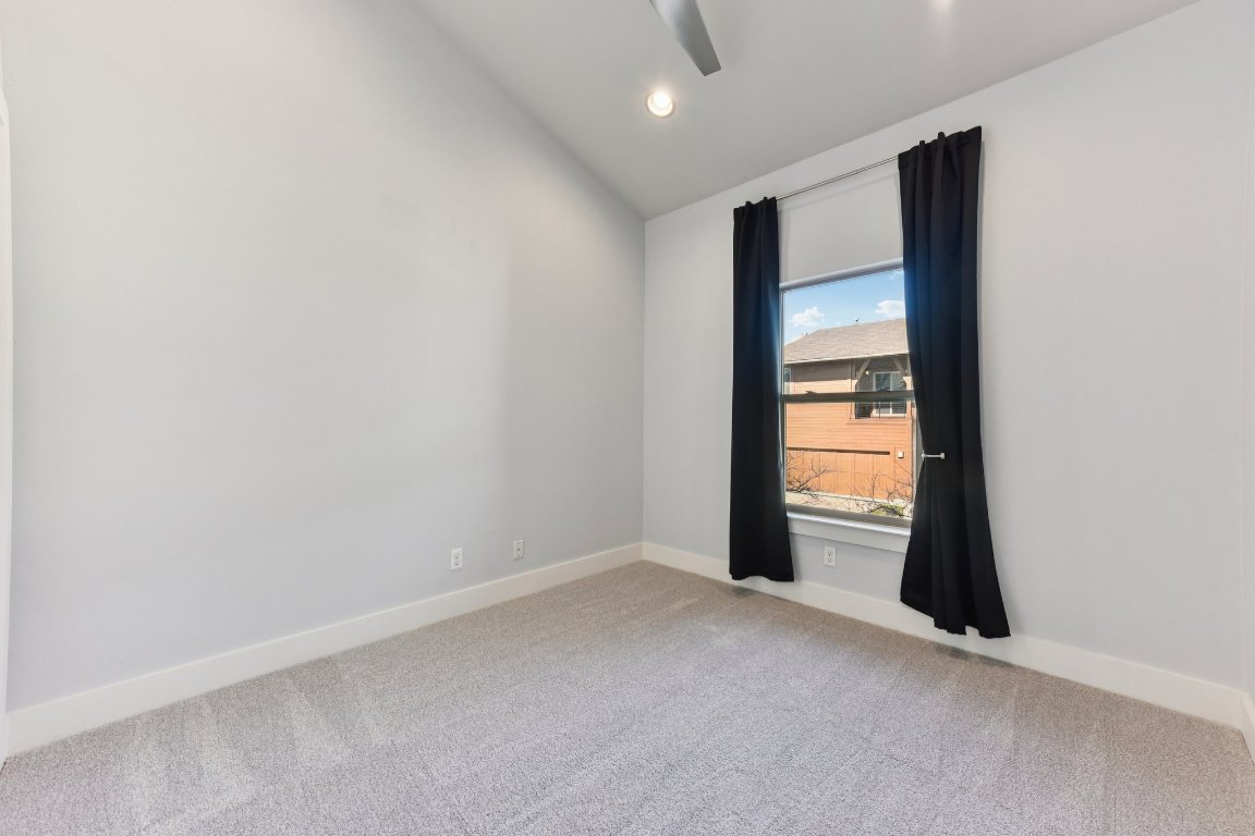8110 Ranch Road 2222, Unit 98 Austin, TX 78730 - Photo 24 of 37 Empty room featuring vaulted ceiling, light colored carpet, and recessed lighting
