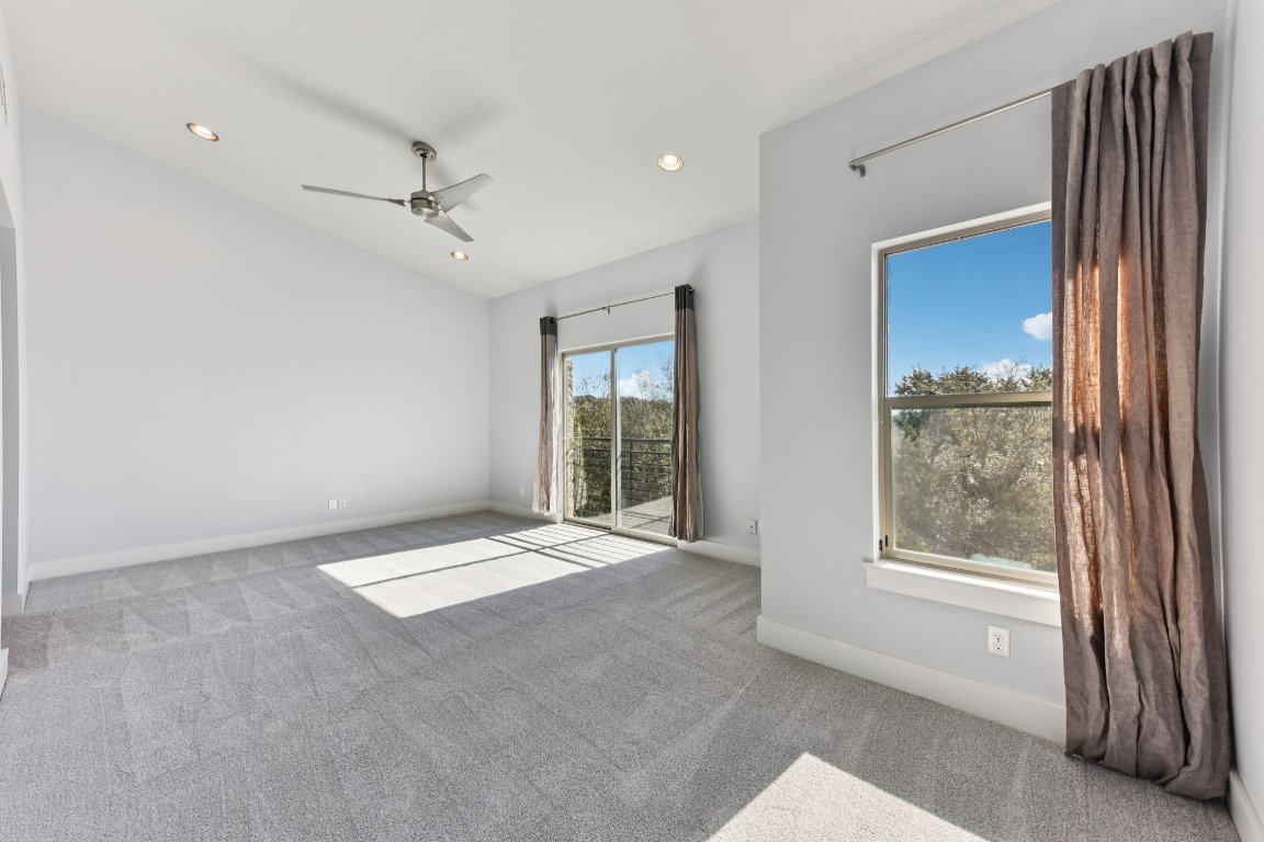 8110 Ranch Road 2222, Unit 98 Austin, TX 78730 - Photo 26 of 37 Carpeted empty room featuring a ceiling fan, recessed lighting, and lofted ceiling