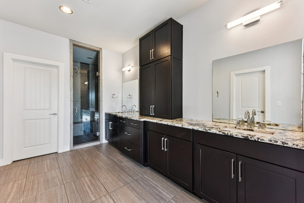 8110 Ranch Road 2222, Unit 98 Austin, TX 78730 - Photo 29 of 37 Bathroom featuring double vanity, a stall shower, and recessed lighting