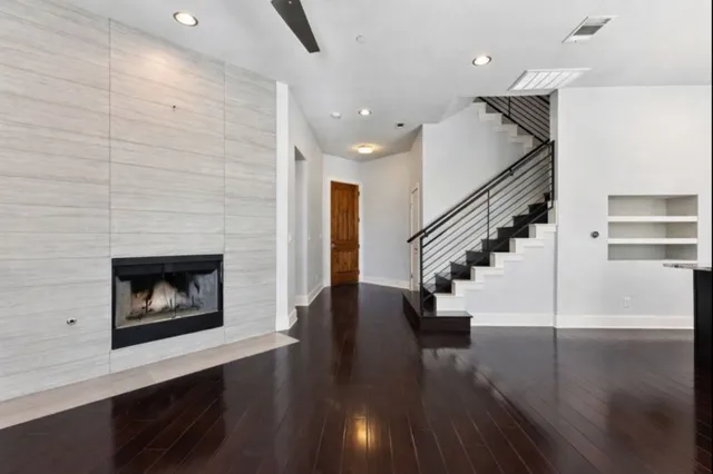 an empty room with wooden floor and fireplace