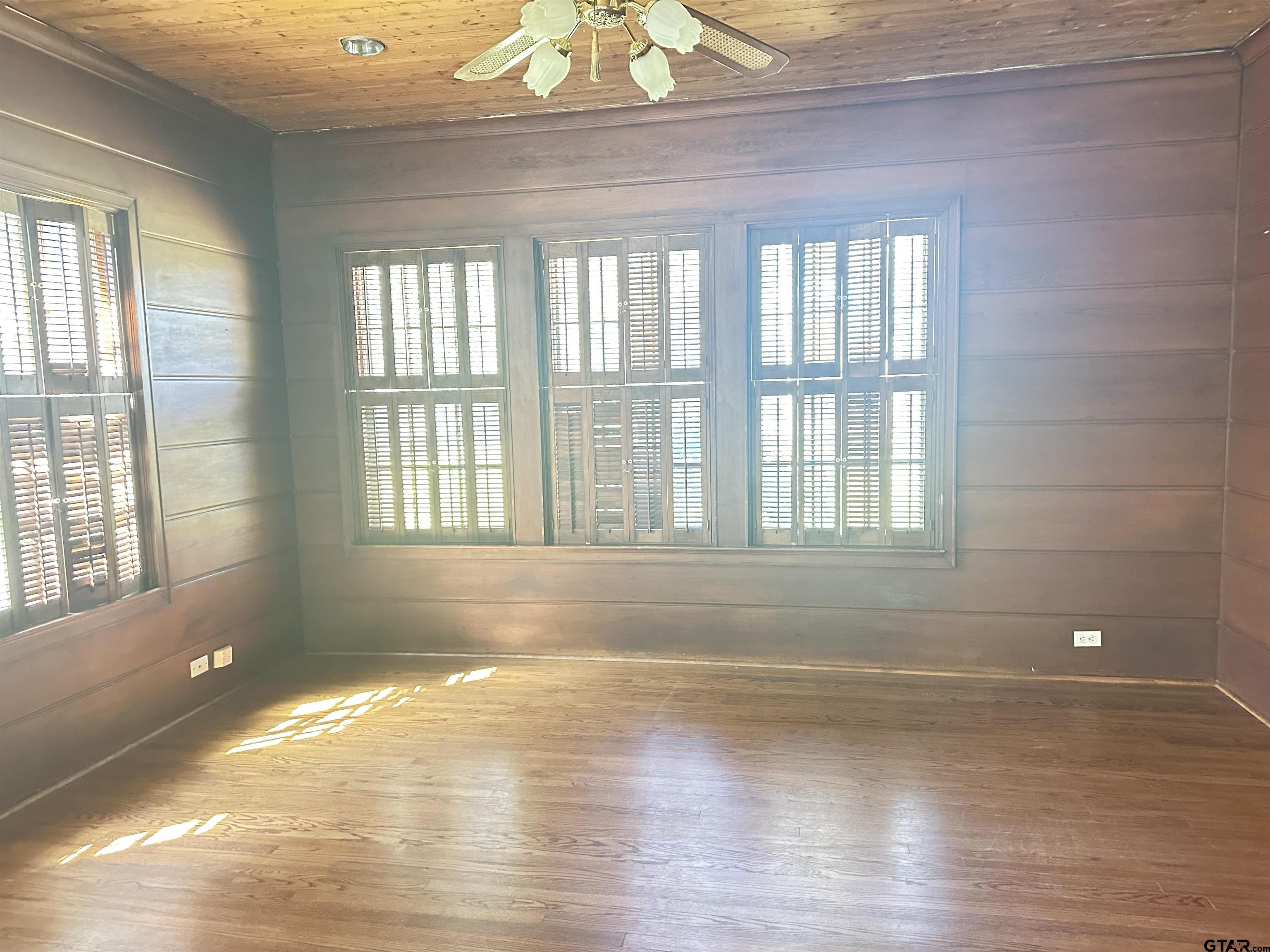 2337 East Rusk Street Jacksonville, TX 75766 - Photo 13 of 47 a view of empty room with wooden floor and fan