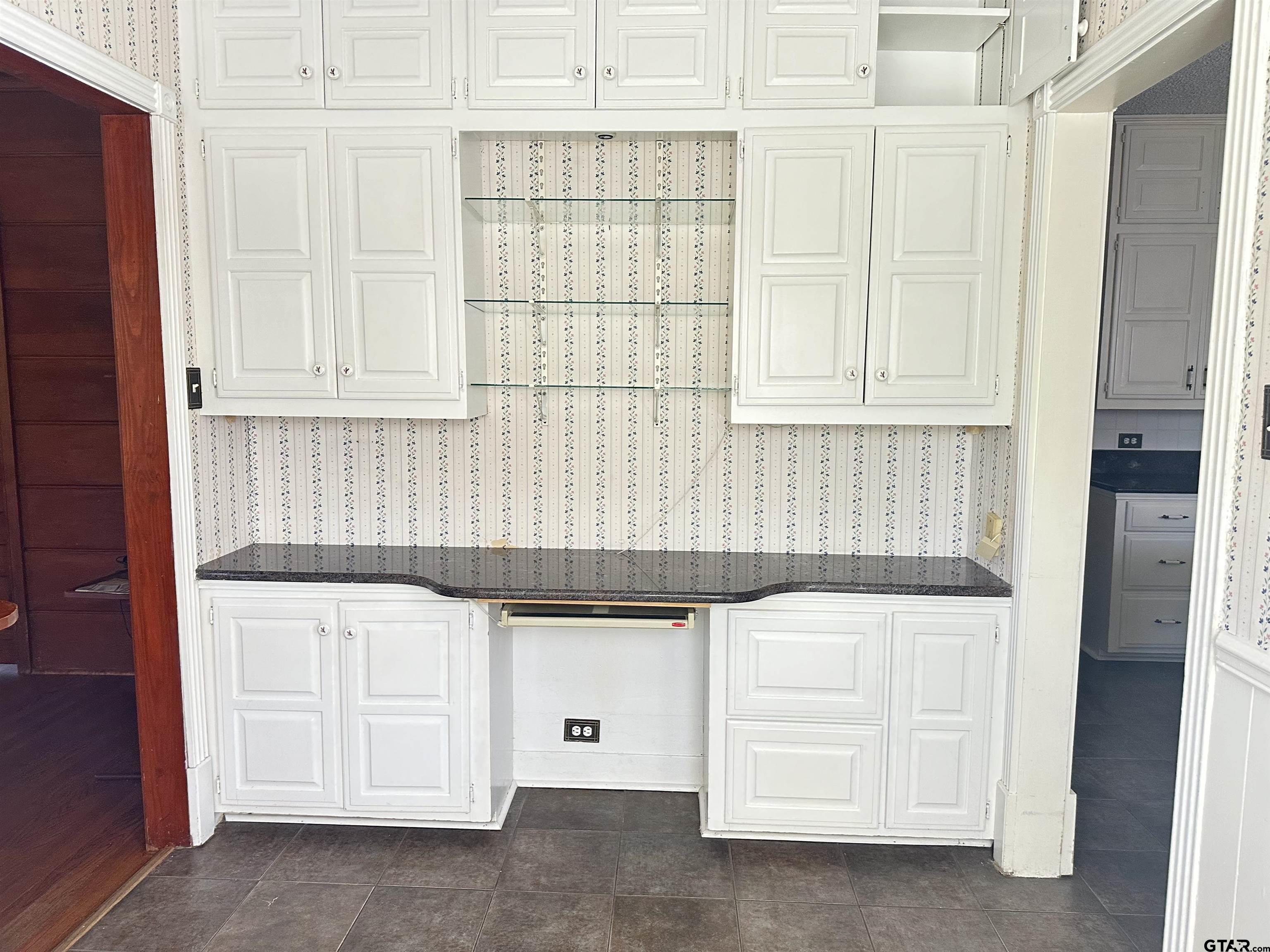 2337 East Rusk Street Jacksonville, TX 75766 - Photo 15 of 47 a kitchen with granite countertop white cabinets and sink