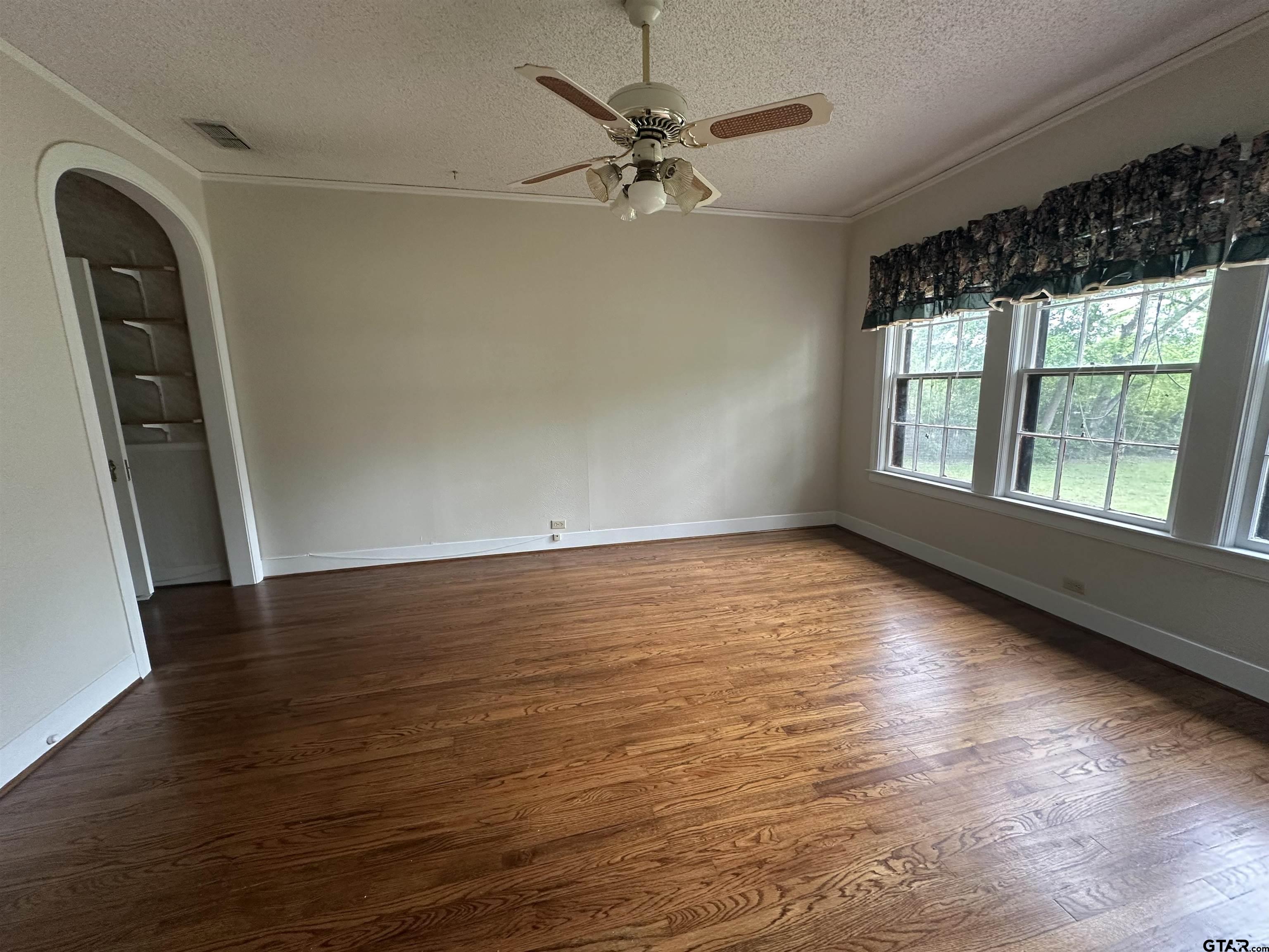2337 East Rusk Street Jacksonville, TX 75766 - Photo 20 of 47 wooden floor in an empty room with a window