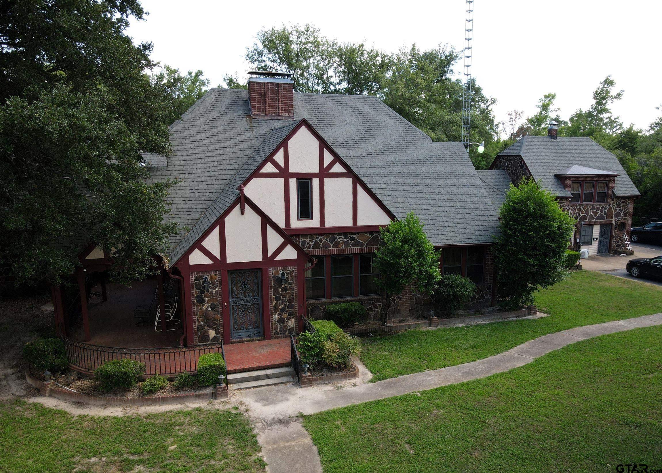 2337 East Rusk Street Jacksonville, TX 75766 - Photo 2 of 47 a view of house with garden and tall trees