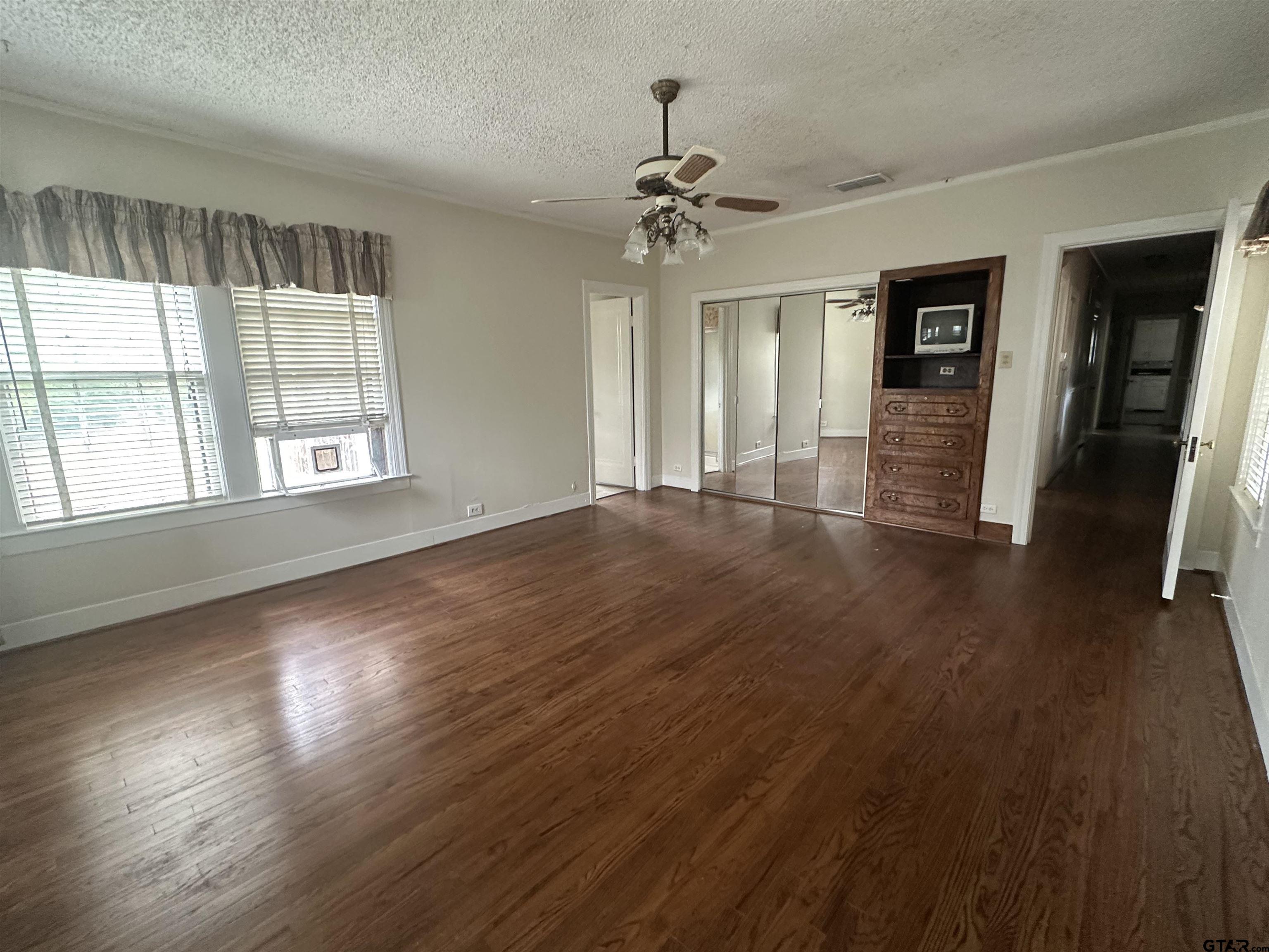2337 East Rusk Street Jacksonville, TX 75766 - Photo 25 of 47 wooden floor in an empty room with a window