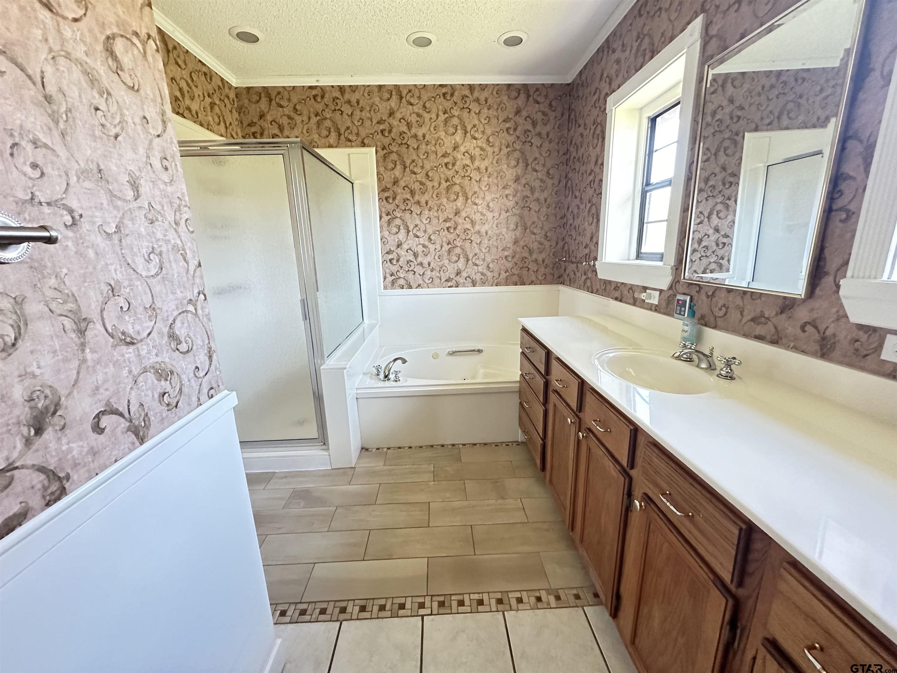 2337 East Rusk Street Jacksonville, TX 75766 - Photo 26 of 47 a bathroom with a tub sink and mirror
